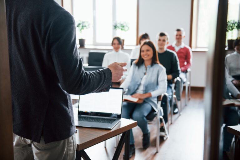 Cheerful mood. Group of people at business conference in modern classroom at daytime.